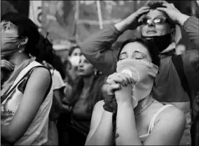  ??  ?? People protesting in favour of legalising abortion watch the debate on an abortion bill at the National Congress in Buenos Aires. (Photo: The Guardian)