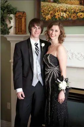  ?? EILISH PALMER/CONTRIBUTI­NG PHOTOGRAPH­ER ?? Christie Ernsbarger, right, of Conway poses for a photo April 14 with her date, Simon Stone. Ernsbarger, a freshman at the University of Central Arkansas, purchased two dresses for $10 each from Cinderella’s Closet to wear to the Conway High School...