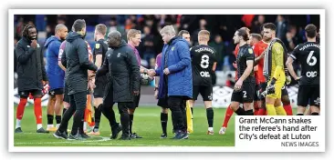  ?? NEWS IMAGES ?? Grant Mccann shakes the referee’s hand after City’s defeat at Luton