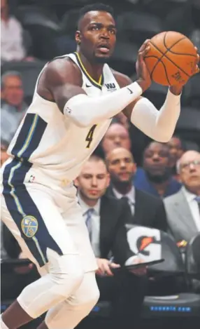  ?? John Leyba, The Denver Post ?? Paul Millsap, left, joined the Nuggets during the offseason with the hope of complement­ing returning star big man Nikola Jokic, right. Those two have all-around games that in a sense could be considered similar. Coach Michael Malone expects them...