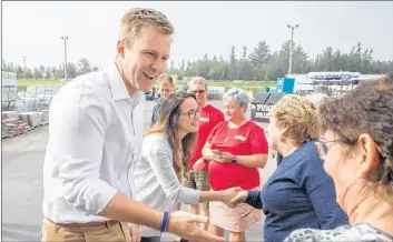  ?? CP PHOTO ?? New Brunswick Liberal Leader Brian Gallant and wife Karine Lavoie are greeted by supporters after arriving at a campaign stop in Oromocto, N.B., on Saturday.