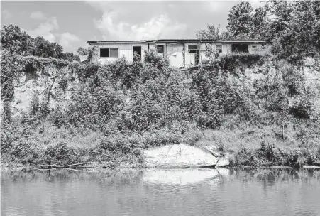  ?? William Luther / Staff photograph­er ?? Macon says he lost 90 feet of land to the Colorado River. He has built a new home on his Travis County property farther from the bank. “I had a nice beach down there,” he said. “I had a boat ramp.”