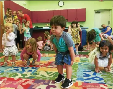  ?? ZACH SRNIS — THE MORNING JOURNAL ?? Children dance during the Family Story Time June 25 at Avon Lake Public Library.