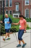  ?? MICHILEA PATTERSON — DIGITAL FIRST MEDIA ?? Lucie Bergeyova, on the right, teaches a man the technique for Nordic Walking during a seminar at the Pottstown Middle School.