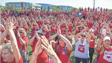  ?? TOM TINGLE/THE REPUBLIC ?? Teachers and supporters of the #RedForEd movement celebrate Thursday near the state Capitol. Earlier Thursday, Gov. Doug Ducey approved a budget that includes nearly $273 million aimed at teacher pay raises.