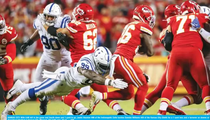  ?? — AFP ?? KANSAS CITY: With 5:06 left in the game and fourth down and 1-yard to go, Justin Houston #99 of the Indianapol­is Colts tackles Damien Williams #26 of the Kansas City Chiefs for a 1-yard loss and a turnover on downs at Arrowhead Stadium in Kansas City, Missouri. The Colts won, 19-13.