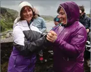  ??  ?? Never mind the weather… Marie Coffey and Margaret ‘Sonny’ O’Sullivan, set dancing on the bridge