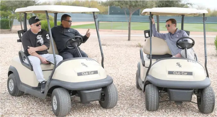  ?? JOHN ANTONOFF/FOR THE SUN-TIMES ?? Sox manager Rick Renteria (far left) and executive vice president Ken Williams chat with general manager Rick Hahn (right) on the first day of camp.