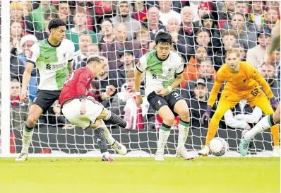  ?? AP ?? Manchester United’s Antony (second left) scores his side’s second goal during the FA Cup quarterfin­al match between Manchester United and Liverpool at the Old Trafford stadium in Manchester, England, yesterday.