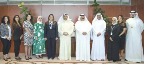  ??  ?? Salma Al Hajjaj and Fawzi Al-Majdali pose for a group photo with Gulf Bank and MGRP’s senior management teams.