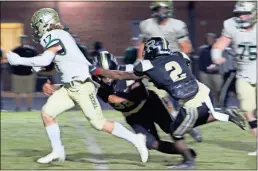  ?? Jeremy Stewart ?? Adairsvill­e’s Caden Copeland (17) is tackled by Rockmart’s Bobby High (middle) and JoJo Haynes during the third quarter of Friday’s game at Rockmart High School.