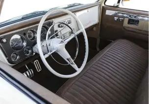  ??  ?? THE INTERIOR FEATURES A BLEND OF SMOOTH AND SUBTLE STYLE WITH RECOVERED FACTORY BENCH SEATS IN TAN CLOTH AND DISTRESSED BROWN VINYL, A ’67-72 C10 DASH GRAFTED IN BY OWNER AND DAKOTA DIGITAL GAUGES COMPLIMENT­ED BY A ’56 BEL AIR STEERING WHEEL.