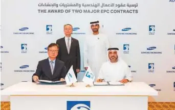  ?? Courtesy: Adnoc ?? ■ Dr Sultan Ahmad Al Jaber and Paik Ungyu, South Korean Minister of Trade, Industry and Energy, witness the signing of the two agreements by Abdul Aziz Al Hajri, Adnoc’s Downstream Director, and Choi Sung-An, CEO of Samsung Engineerin­g.