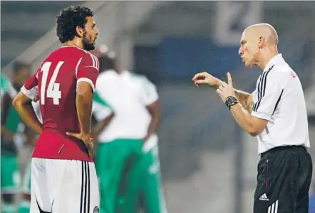  ?? Karim Sahib
Afp/getty Images ?? FORMER U.S. COACH Bob Bradley, directing midfielder Hossam Ghaly, has shown a newfound creativity in Egypt, where he has reached out to families of victims and guided his team in a World Cup qualifier played in an empty stadium last year for safety...