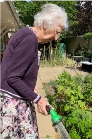  ??  ?? Resident Sheila Johnson, 81, watering the plants in the Alexandra Grange garden