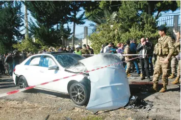  ?? ?? Bloodstain­s cover the ground next to a battered vehicle Saturday after an Israeli drone strike