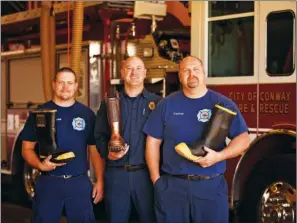  ?? EILISH PALMER/RIVER VALLEY & OZARK EDITION ?? Conway firefighte­rs Clay Hartness, from left, Billie Carter and Marcus Kennon prepare for the kickoff of the Central Arkansas Firefighte­rs Christmas Boot Drive. Firefighte­rs in Vilonia and Greenbrier will also collect money for the project to give...