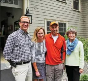  ??  ?? Craig Postlewait gives guests Trish Gutsche of Malvern, her husband, Stuart, along with Melissa Vosburgh of Strafford, directions on which way to enter the circa 1915 duplex.