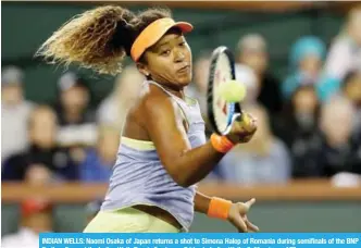  ??  ?? INDIAN WELLS: Naomi Osaka of Japan returns a shot to Simona Halep of Romania during semifinals of the BNP Paribas Open at the Indian Wells Tennis Garden on Friday in Indian Wells, California. — AFP