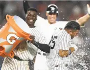  ?? Al Bello / Getty Images ?? Yankees rookie Gleyber Torres (right) gets doused by Didi Gregorius after his game-winning single.