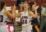  ?? AUSTIN HERTZOG - DIGITAL FIRST MEDIA ?? Pottsgrove’s Riley Simon (24) high-fives teammate Sydney Mowery after the final buzzer of the Falcons’ 32-30 win over Pope John Paul II Thursday.