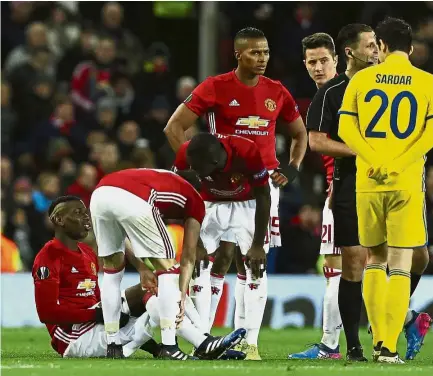  ?? — AP ?? Down and out: Manchester United’s Paul Pogba sits on the ground after getting injured during the Europa League last 16 second-leg match against Rostov at Old Trafford on March 16.