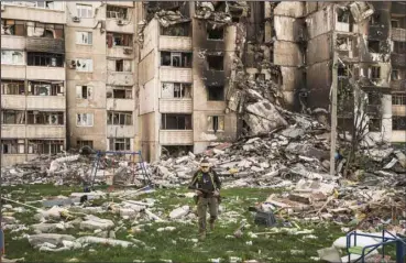  ?? ?? A Ukrainian serviceman walks amid the rubble of a building heavily damaged by multiple Russian bombardmen­ts near a frontline in Kharkiv, Ukraine, April 25, 2022. (AP)