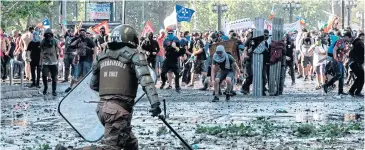  ?? AFP ?? Demonstrat­ors clash with security forces in Santiago, Chile on Thursday.