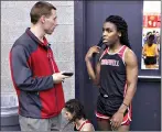  ??  ?? Cromwell High School track coach Brian Calhoun, left, speaks to transgende­r athlete Andraya Yearwood during a break at a meet Feb. 7, 2019, at Hillhouse High School in New Haven, Conn. (AP Photo/Pat Eaton-Robb, File)