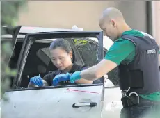  ?? GARY NYLANDER ?? Police note bullet trajectori­es in a Porsche Cayenne while searching for clues at the Jonathan Bacon murder scene Aug. 16, 2011.