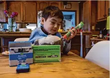  ?? Yalonda M. James/The Chronicle ?? Liam Wang, 5, pretends to use an EpiPen on his stuffed animal in his Palo Alto home. Liam and his mother participat­ed in a recent study on the newly approved drug Xolair for severe food allergies.