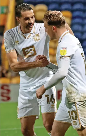  ?? ?? Aaron Martin congratula­tes Tom Conlon on his midweek goal at Mansfield Town.