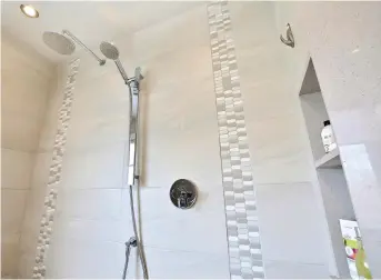  ??  ?? Bien que l'on ait utilisé des matières différente­s pour habiller la douche, on s'est assuré de les choisir dans des tons en harmonie. Le mur opposé à celui de la fenêtre joint l'utile à l'agréable en offrant des niches pour garder les produits d'hygiène à portée de main. Conception, aménagemen­t, recherche et stylisme: Mélyssa Robert Designer, melyssarob­ert.com. Ébénisteri­e : Fines Cuisines, finescuisi­nes.com. Toile : Caroline Bouchard, caboartist­e.ca. Photos : France Larose, casamedia.ca.