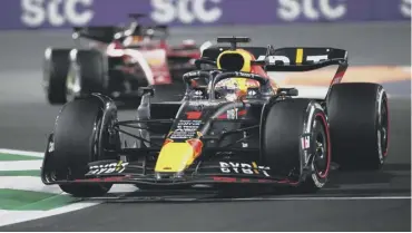  ?? ?? Verstappen driving his Red Bull car leads Leclerc in his Ferrari during a battle that went to the wire