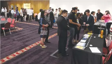  ?? AP PHOTO/ANNIE RICE ?? People attend a June 20 job fair in Chicago. On Friday, the U.S. government issues the November jobs report.