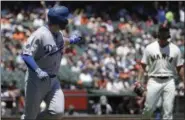  ?? JEFF CHIU — THE ASSOCIATED PRESS ?? Dodgers’ Max Muncy, left, gestures while running up the first base line after hitting a solo home run off of Giants pitcher Madison Bumgarner, right, in San Francisco, Sunday.