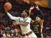  ?? ERIC ESPADA / GETTY IMAGES ?? Chris Lykes maneuvers past Florida State’s M.J. Walker on a drive to the hoop during his 18-point performanc­e in Miami’s 80-74 ACC victory.