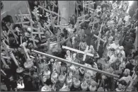  ?? File photo ?? Orthodox Christians hold crosses during a past Good Friday procession at the Church of the Holy Sepulcher, traditiona­lly believed to be the site of the crucifixio­n of Christ, in Jerusalem’s Old City.