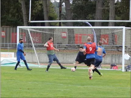  ?? MARY BENJAMIN — FORT BRAGG ADVOCATE-NEWS ?? Students from Noyo High School and a group of US Coast Guardsmen play a game of soccer on Timberwolf Field.