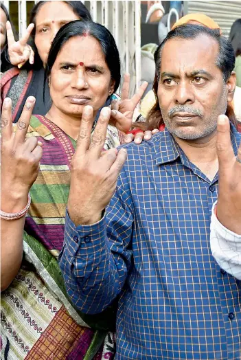  ?? — PTI ?? Nirbhaya rape and murder case victim’s parents react at Dwarka in New Delhi on Friday after four men convicted of the crime were executed inside Tihar jail.