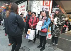  ?? MORIO TAGA / JIJI PRESS ?? Chinese tourists visit a duty-free shop at Akihabara electric district of Tokyo.