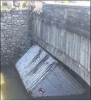  ??  ?? A large shipping container was wedged under the Springfiel­d Road bridge in Darby.