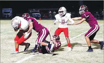  ?? Westside Eagle Observer/RANDY MOLL ?? Gentry’s Caydon Koons and Jordan Trammell catch the Green Forest quarterbac­k behind the line of scrimmage for a loss during Friday’s game against Green Forest in Pioneer Stadium.