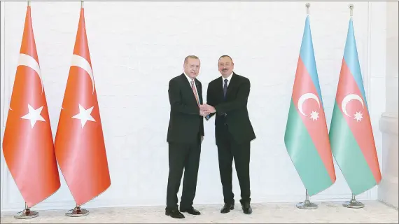  ??  ?? President Ilham Aliyev shake hands with Turkish President Recep Tayyip Erdogan as part of his official visit to Baku on July 10.