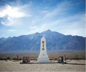  ??  ?? A monument honouring the dead stands in the cemetery at the Manzanar Japanese internment centre in California.