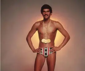  ??  ?? Tight fit: Mark Spitz in 1973 with the seven gold medals he won in the 1972 Olympics… and his Speedos. Photograph: Terry O’Neill/Getty Images