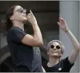  ?? SETH WENIG — THE ASSOCIATED PRESS ?? The U.S. women’s soccer captains Alex Morgan, left, and Megan Rapinoe join in the celebratio­n during Wednesday’s parade and rally.