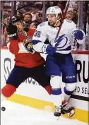  ?? Lynne Sladky / Associated Press ?? Panthers defenseman Brandon Montour, left, and Lightning left wing Brandon Hagel go against the boards during a game in April.