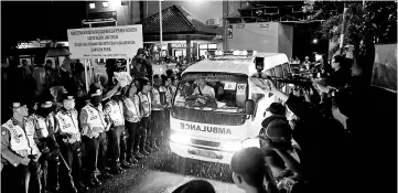  ??  ?? File photo shows an ambulance carrying the remains of an executed prisoner leaving the port of the prison island of Nusa Kambangan island, in Cilacap, Central Java, Indonesia. — Reuters phowo