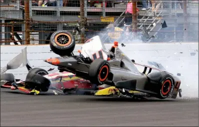  ?? AP/ KIRK STIERWALT ?? Stefano Coletti of Monaco ( right) hits Colombia’s Sebastian Saavedra’s car to start a three- car wreck during the 176th lap of Sunday’s Indianapol­is 500. Saavedra was treated for a foot contusion while Coletti was not injured. Jack Hawksworth, whose...